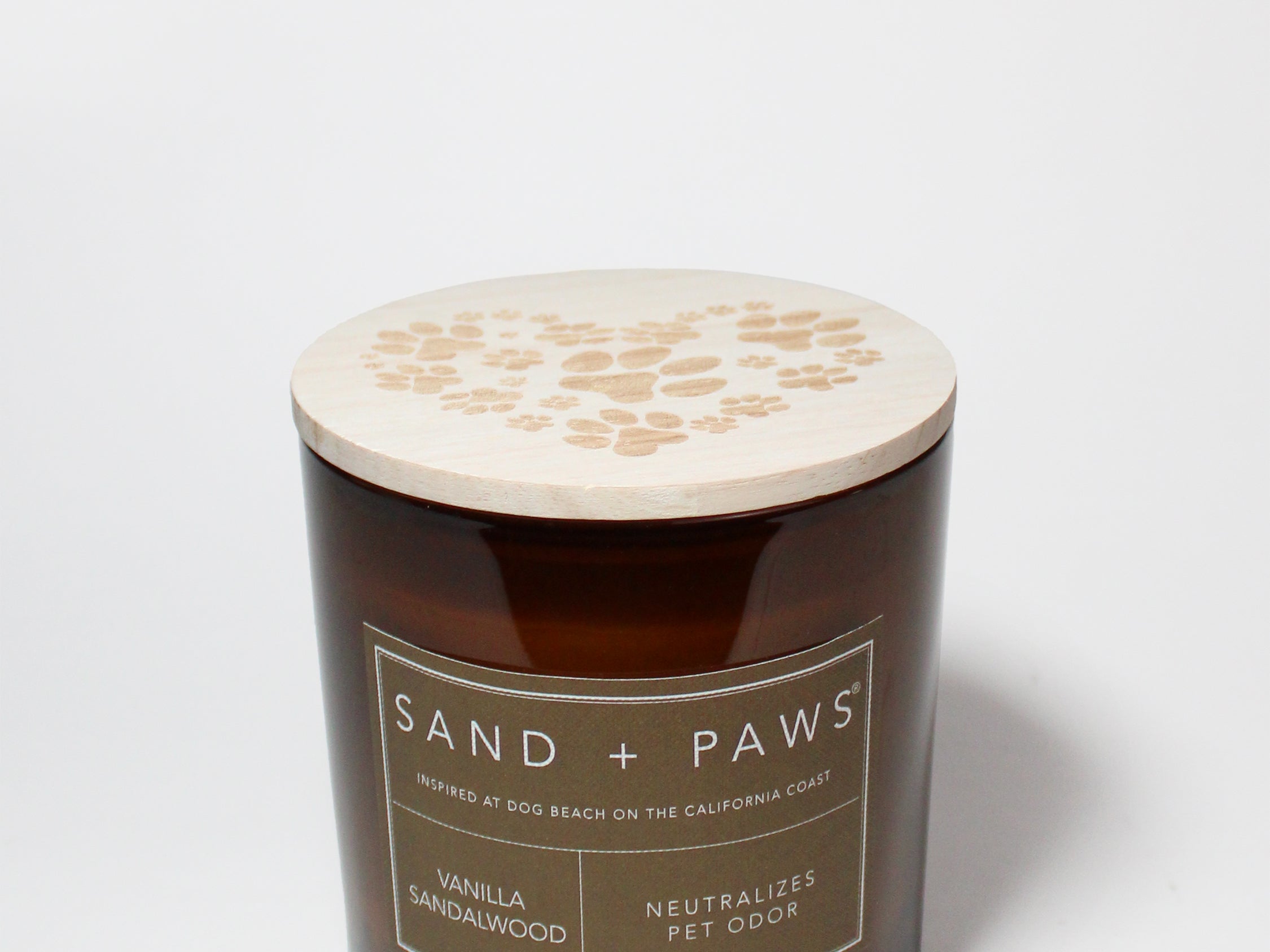 Amber scented candle with wooden lid and Sand + Paws paw-print design