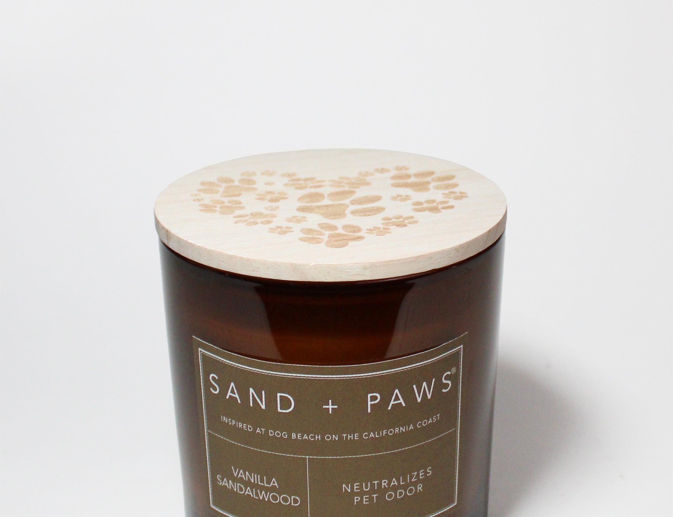 Amber scented candle with wooden lid and Sand + Paws paw-print design