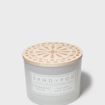 Sand + Fog scented candle jar with wooden-look lid and Cedarwood & Rose label
