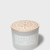 Sand + Fog scented candle jar with wooden-look lid and Cedarwood & Rose label