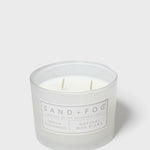 Sandalwood-vanilla scented candle in white glass jar with two wicks