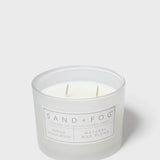 Sandalwood-vanilla scented candle in white glass jar with two wicks