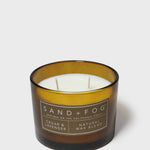 Cedar-scented candle in dark glass jar with amber band and two wicks