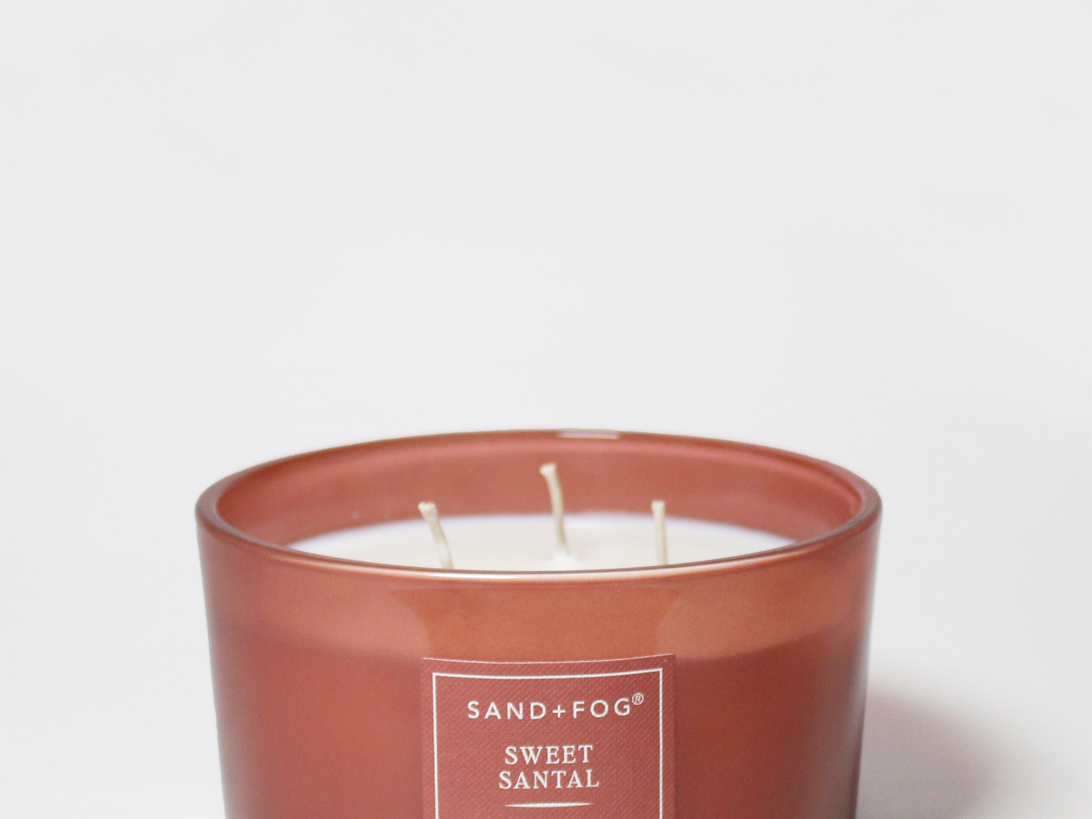Amber glass scented candle jar with two wicks and label, Sweet Santal, 16 oz
