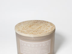 Jasmine scented candle in frosted glass jar with printed label and sealed wax top