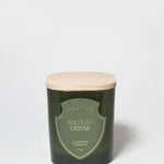 Smoked Cedar scented candle in a dark green glass vessel with a light wood lid.