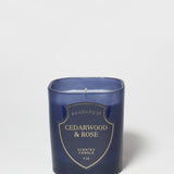 Cedarwood & Rose scented candle in a dark blue glass jar, shown without a lid