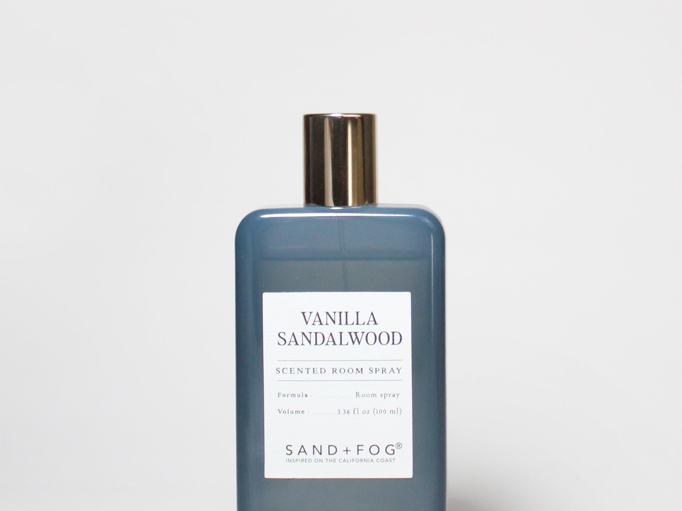 Blue glass room spray bottle with gold cap and Vanilla Sandalwood label, 100 ml