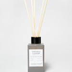 Topgana Canyon reed diffuser in a gray bottle with black cap and several reeds