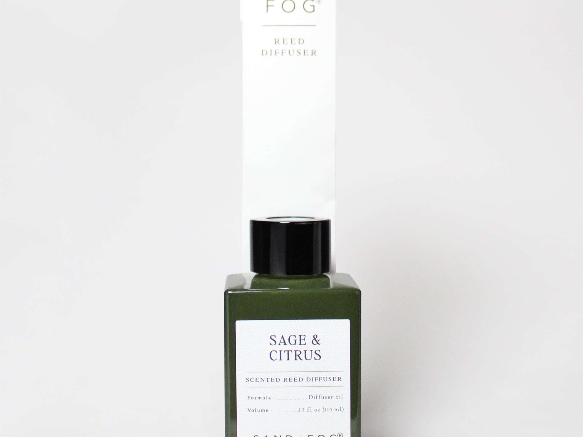 Sage & Citrus reed diffuser in a dark green glass bottle with a black cap and white label.