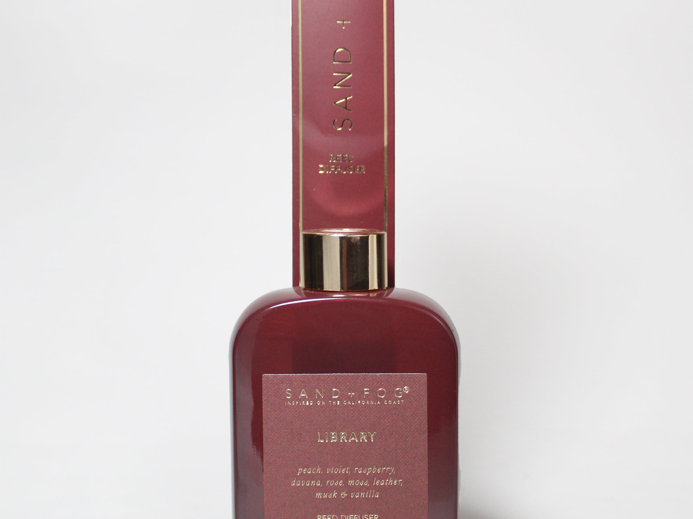 Burgundy 200 ml reed diffuser with gold-tone collar and matching box.