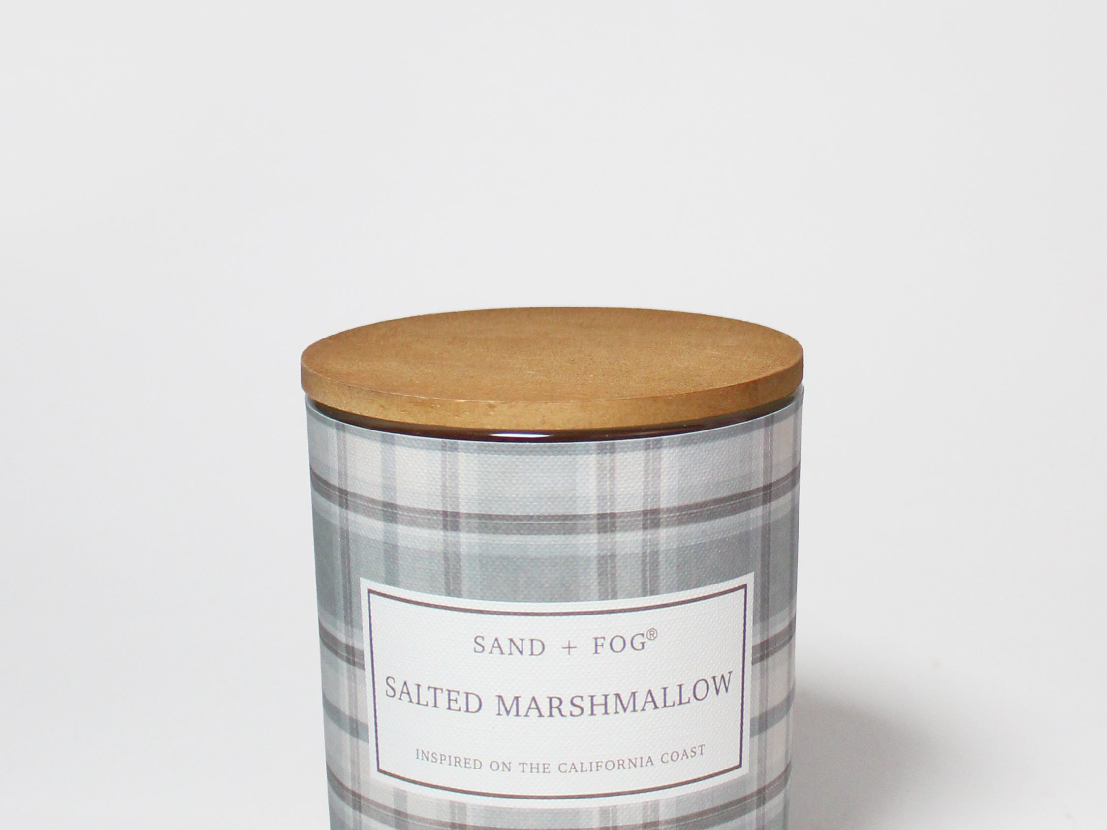 Salted Marshmallow scented candle in a gray plaid glass jar with a round wooden lid.