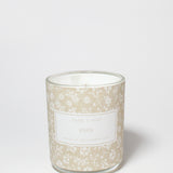 Eden 10 oz scented candle in a glass jar with a beige floral pattern and visible white wax.