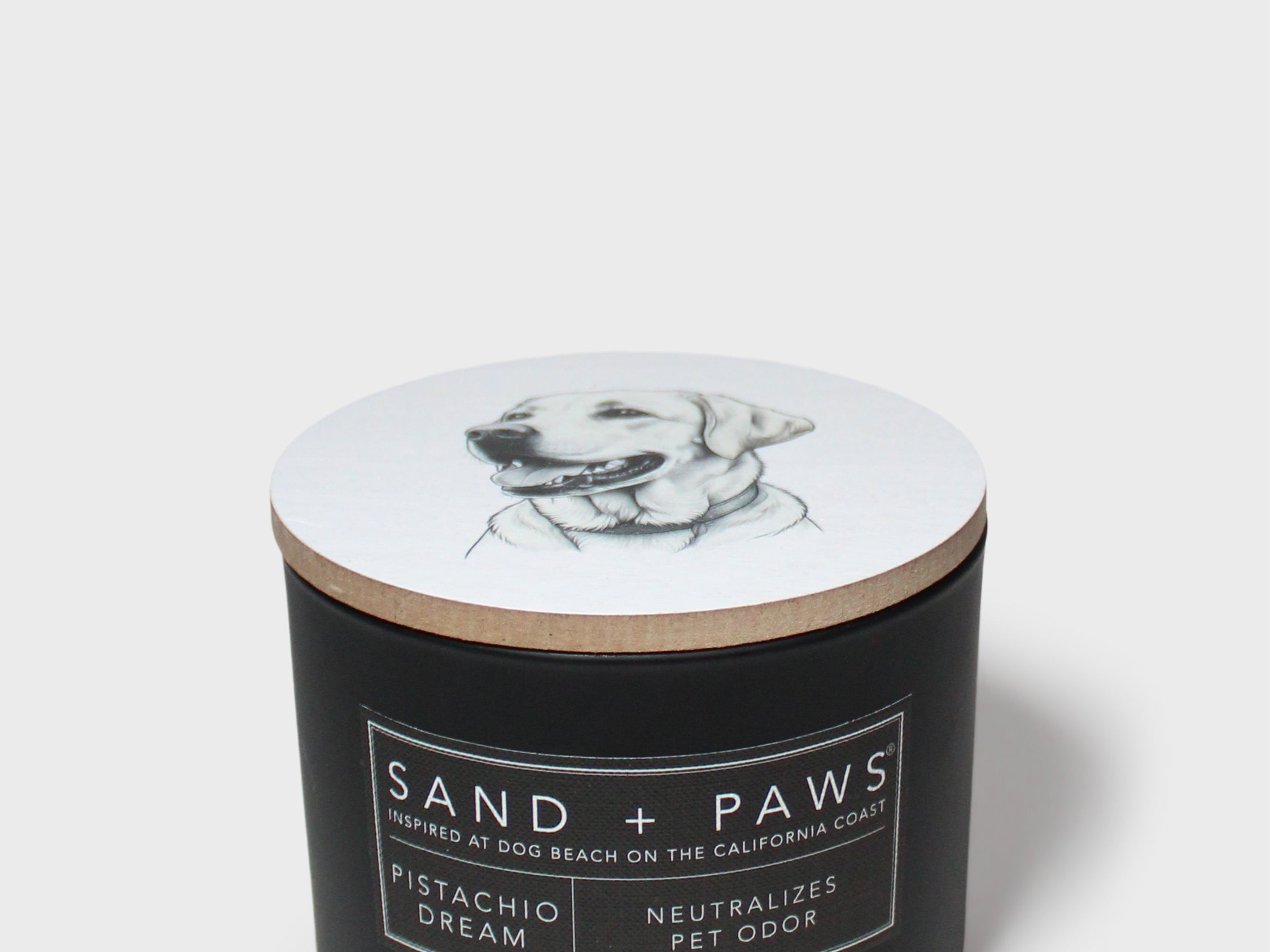 Sand + Paws 12 oz scented candle with dog sketch on lid and label
