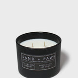 Sand + Paws 12 oz scented candle in black jar with label and three wicks