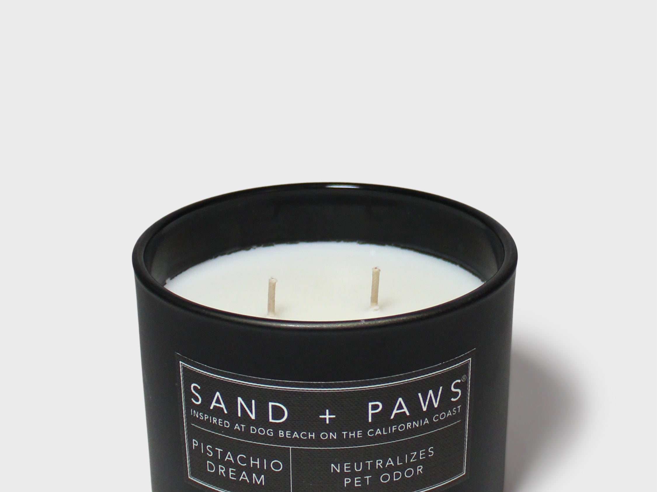 Sand + Paws 12 oz scented candle in black jar with label and three wicks