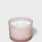 Scented candle in frosted glass jar with Sand + Paws label and three wicks