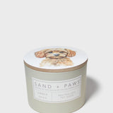 Scented candle jar with dog portrait lid and Sand + Paws Amber Skies label