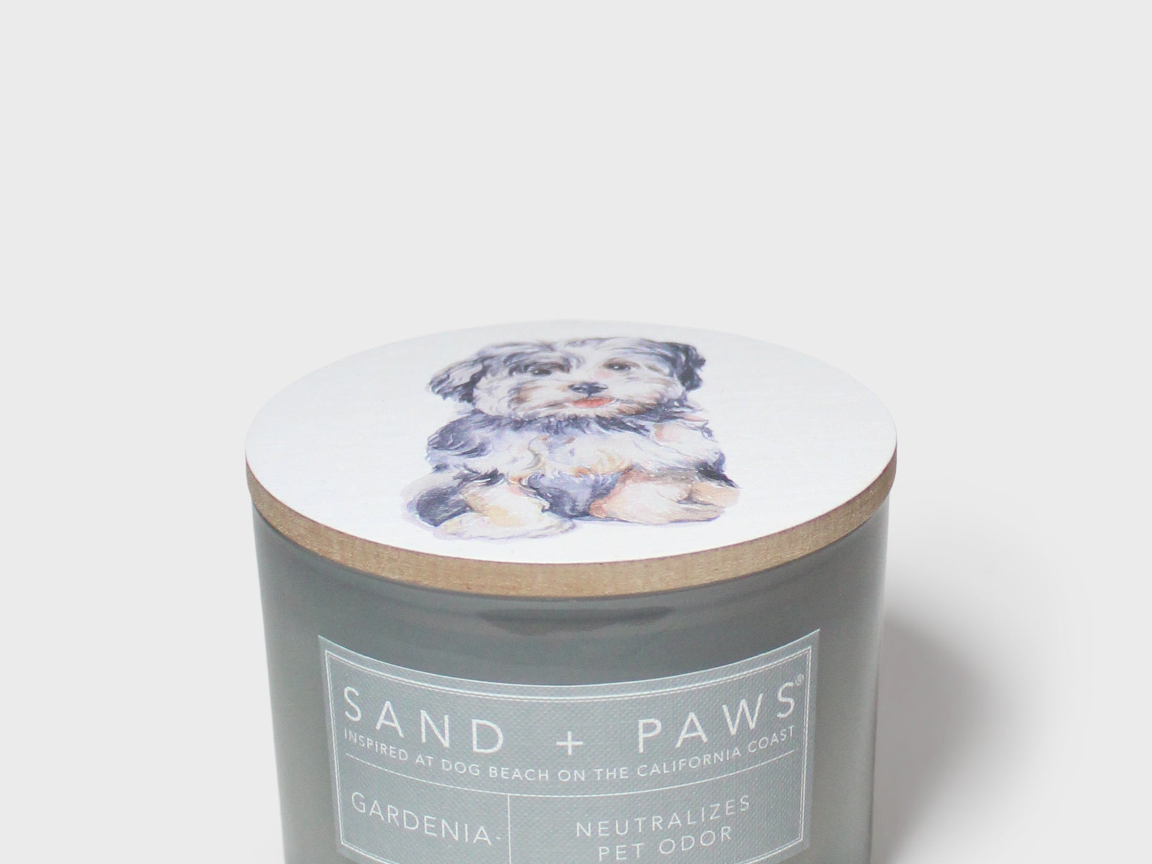 Sand + Paws Gardenia scented candle with dog-illustrated lid and front label