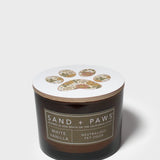 12 oz scented candle in dark glass jar with white lid and paw print emblem.