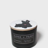 Black jar scented candle with dog graphic lid and Sand + Paws label