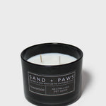 Sand + Paws teakwood scented candle in black glass jar with label