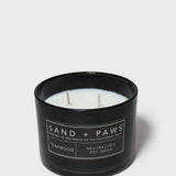 Sand + Paws teakwood scented candle in black glass jar with label