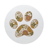 White candle lid with multicolor paw print pattern.