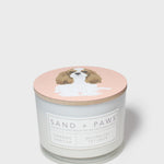 Scented candle jar with dog illustration lid and orange vanilla label
