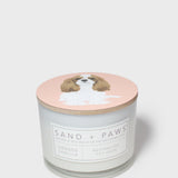 Scented candle jar with dog illustration lid and orange vanilla label