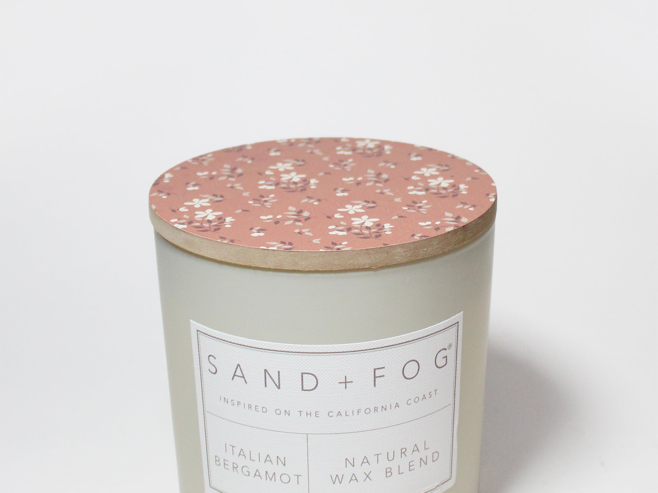 Scented candle tin with rose floral lid and front label
