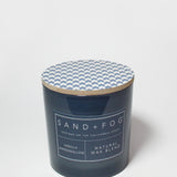 21 oz scented candle with blue chevron lid and dark blue glass jar label