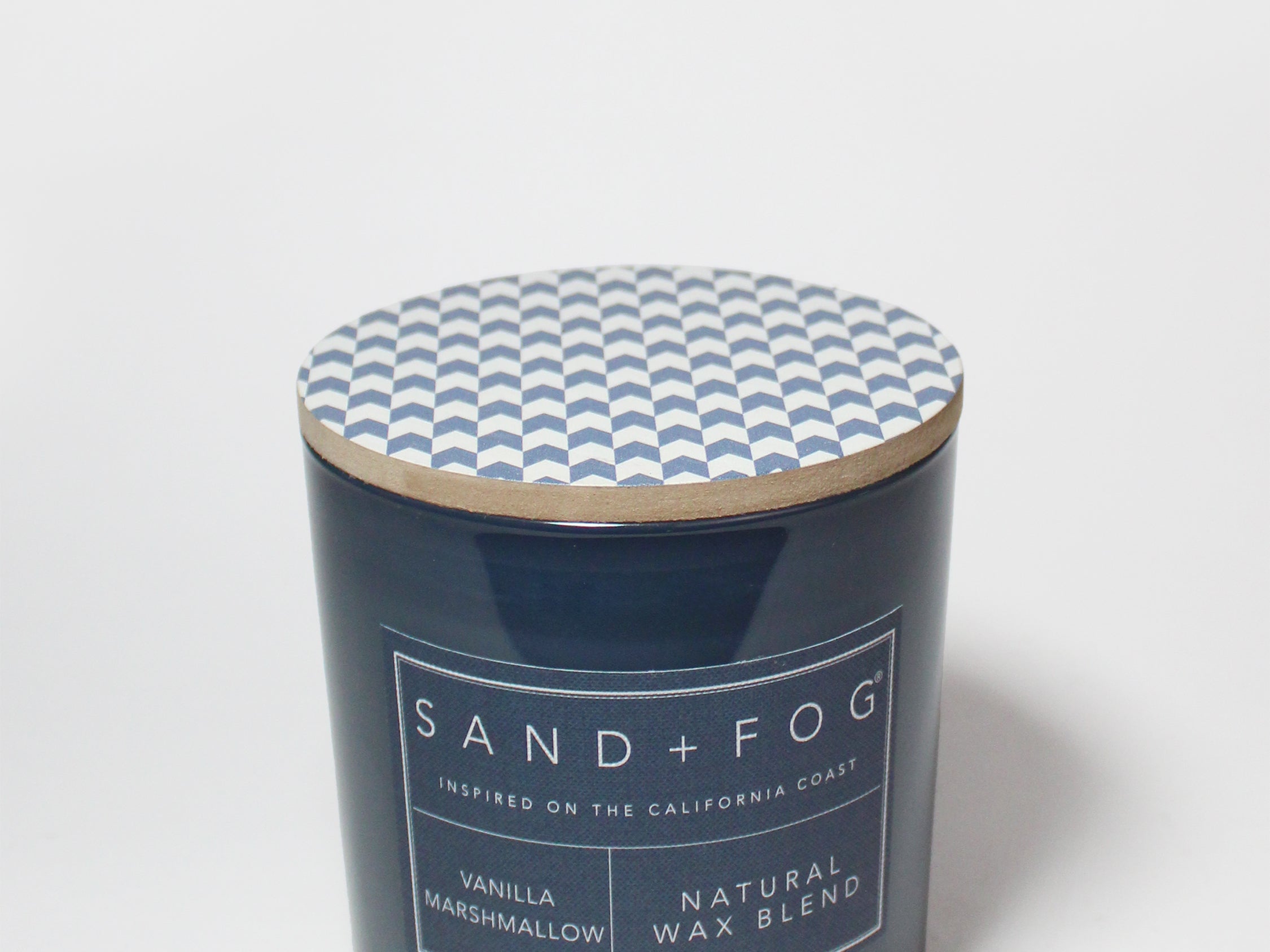 21 oz scented candle with blue chevron lid and dark blue glass jar label
