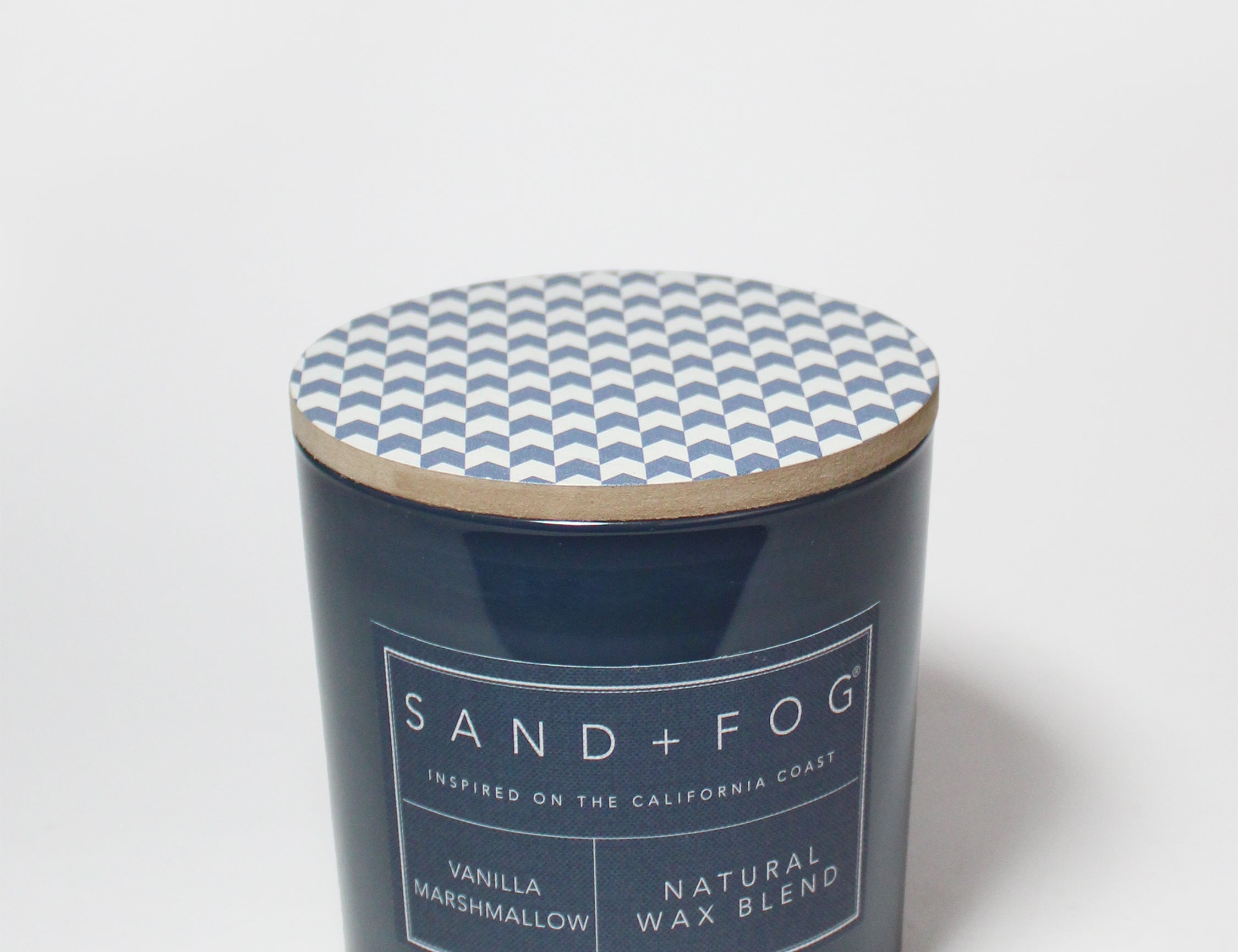21 oz scented candle with blue chevron lid and dark blue glass jar label