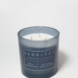 21 oz scented candle in dark blue glass jar with three wicks and label