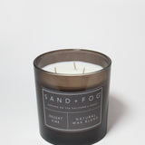 21 oz scented candle in black jar with white label and visible wicks