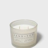 SAND + FOG scented candle jar with two wicks and vanilla sandalwood label