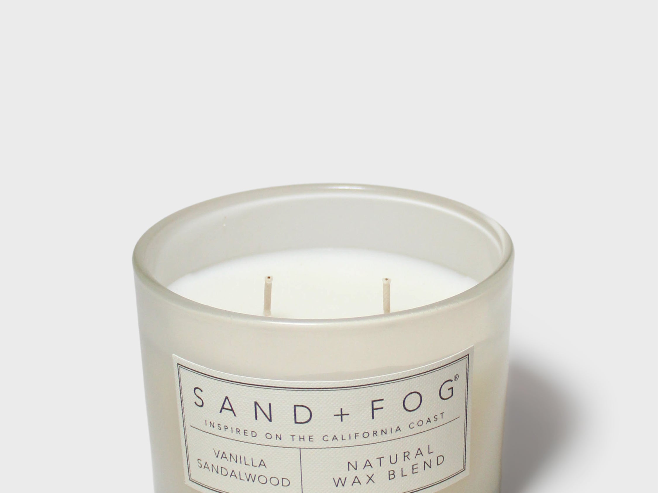 SAND + FOG scented candle jar with two wicks and vanilla sandalwood label