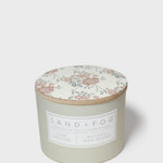 Sand+Fog Love Potion scented candle with floral lid and natural wax blend label