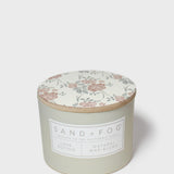Sand+Fog Love Potion scented candle with floral lid and natural wax blend label