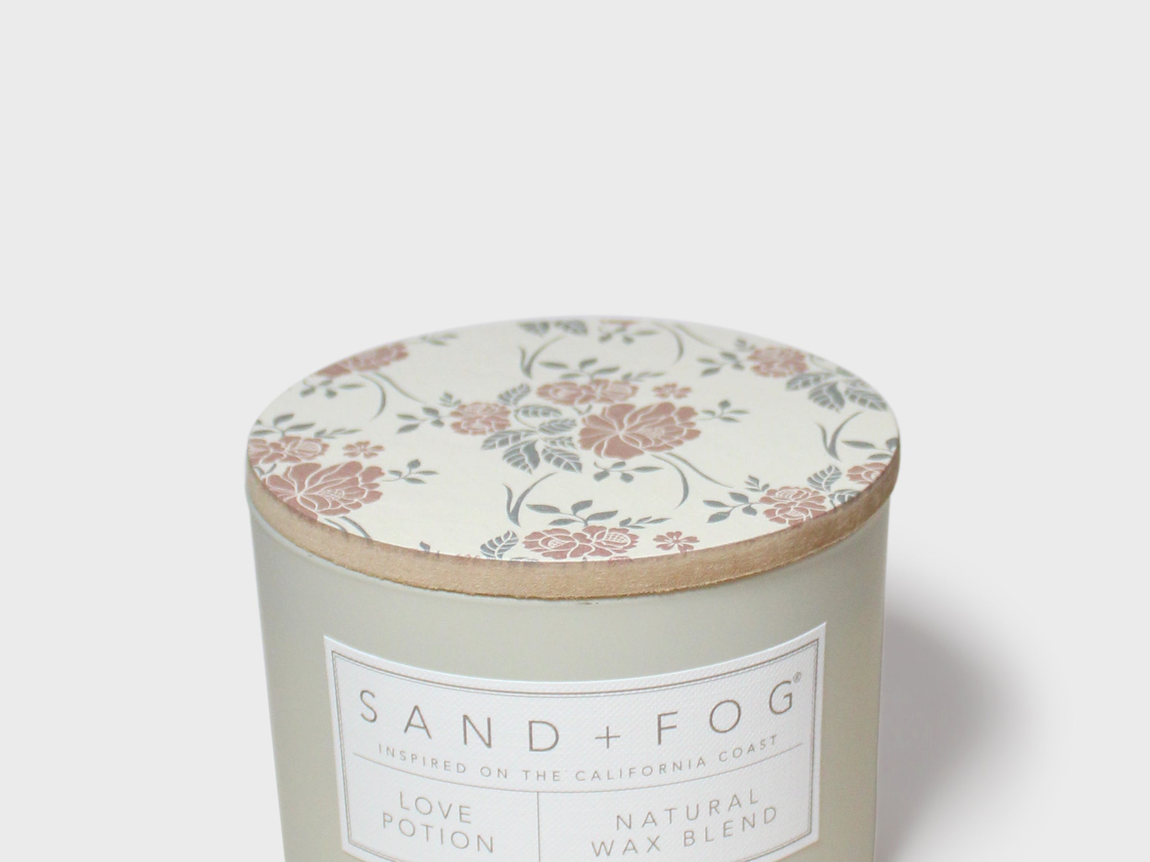 Sand+Fog Love Potion scented candle with floral lid and natural wax blend label