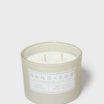 Glass jar scented candle with two wicks and Sand+Fog Love Potion label