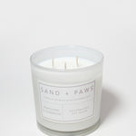 Glass scented candle with Sand + Paws label, Mahogany & Teakwood, and three wicks