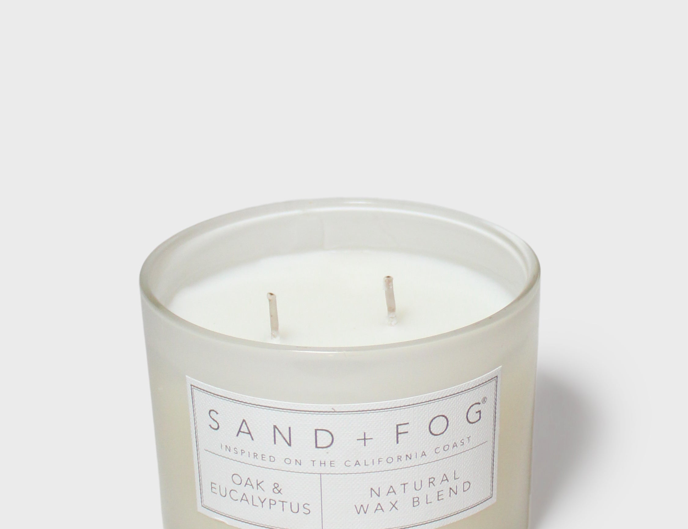 SAND + FOG scented candle jar with two wicks and label, natural wax blend