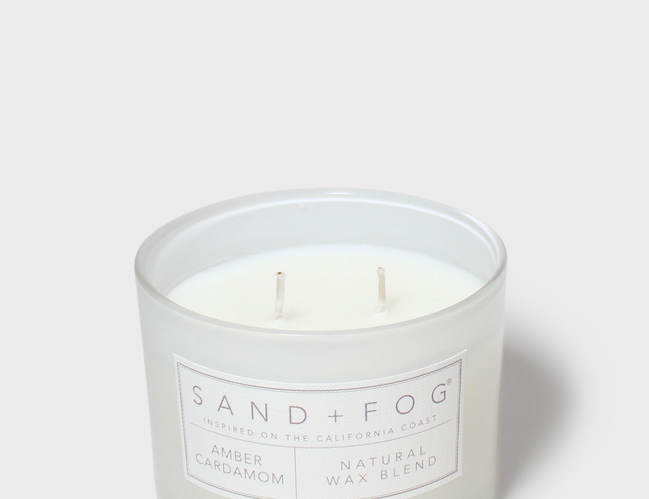 SAND + FOG amber cardamom candle in frosted white jar with two wicks