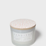 Frosted glass 12 oz scented candle with patterned lid and front label
