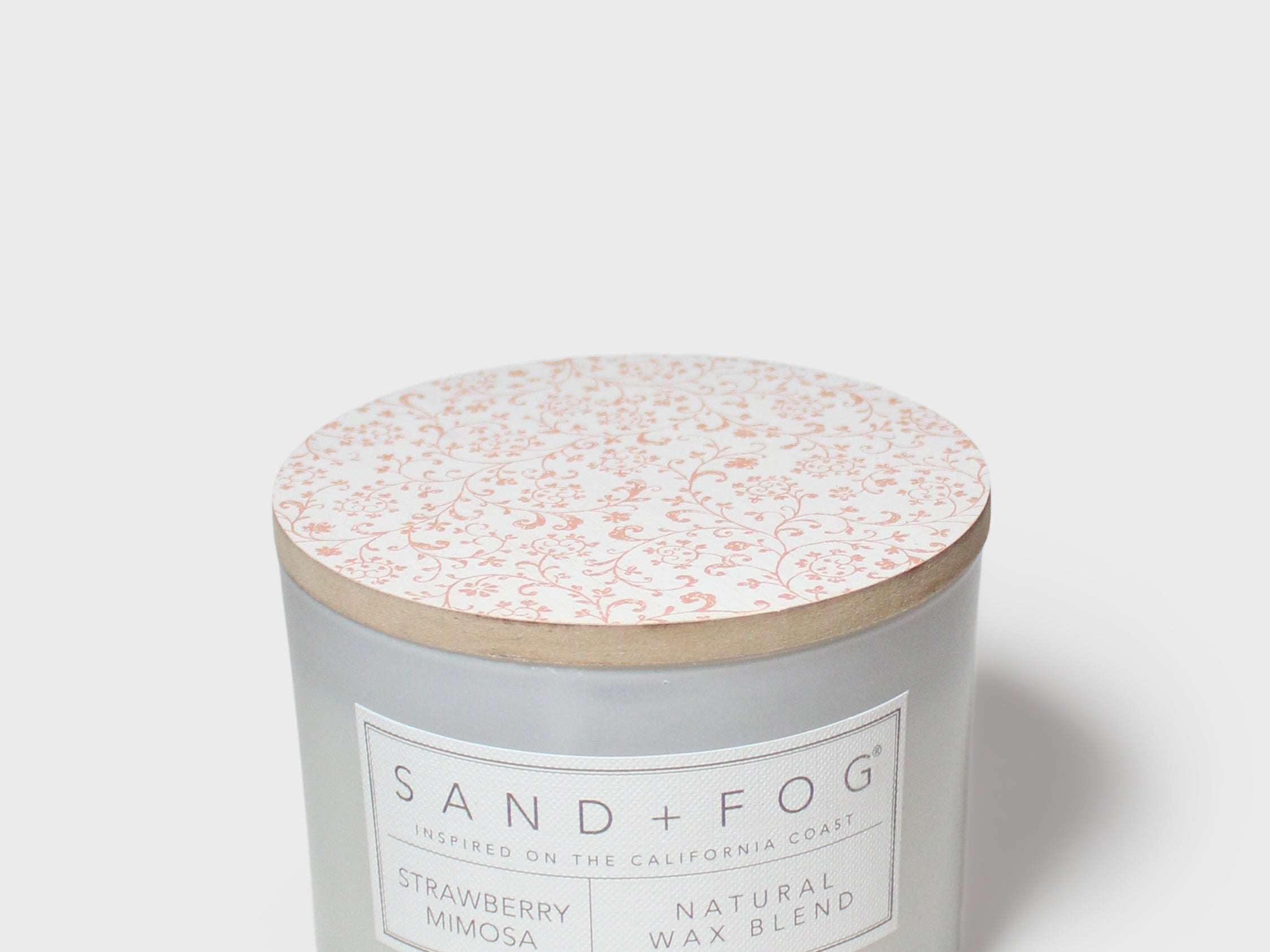 Frosted glass 12 oz scented candle with patterned lid and front label