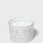 SAND+FOG sage & sea salt scented candle with visible wax and wick in jar