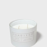 SAND+FOG sage & sea salt scented candle with visible wax and wick in jar