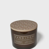 Brown candle jar with speckled top lid and SAND+FOG label